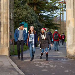 Three students walking through entrance to Singleton Park