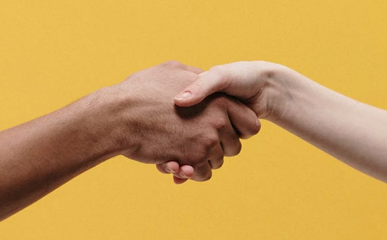 a close up picture of a handshake