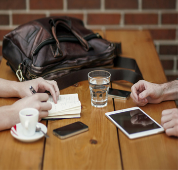 Two people sitting at a coffee table having a discussion