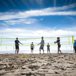 students playing beach volleyball