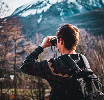 a man looking through some binoculars