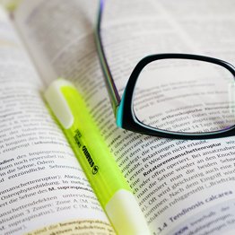 pen and highlighter pen on an open book