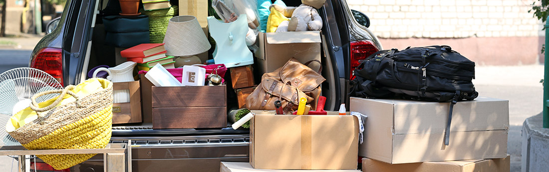 Open car boot packed with boxes and bags