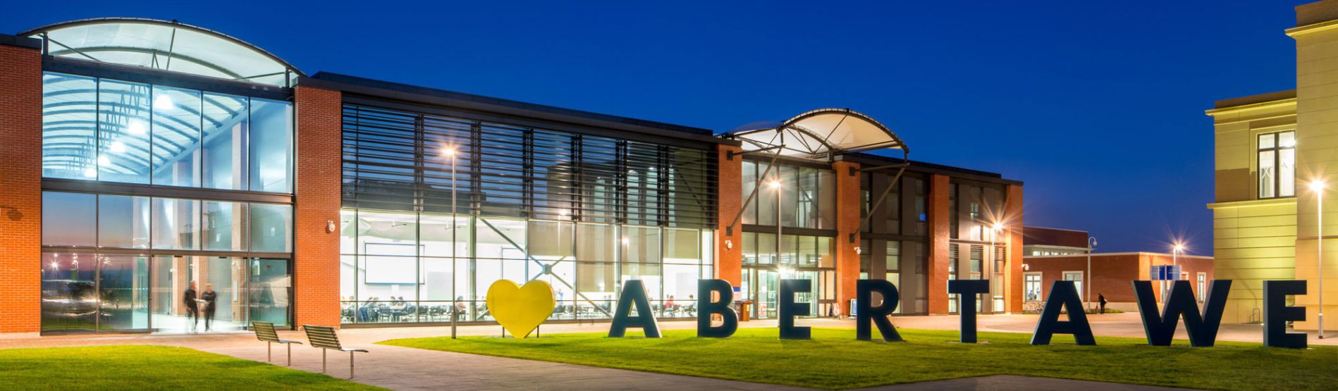 Engineering building at night, with giant letters 'Heart - Abertawe' in the foreground.