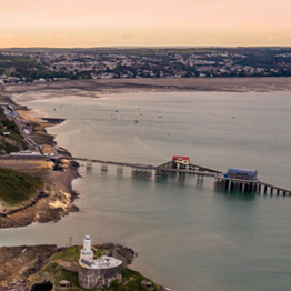Aerial view of Swansea Bay with Mumbles pier and lighthouse in foreground