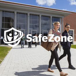Students walking in sunshine on Bay Campus and Safezone logo