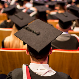 Picture taken from behind of student in graduation ceremony