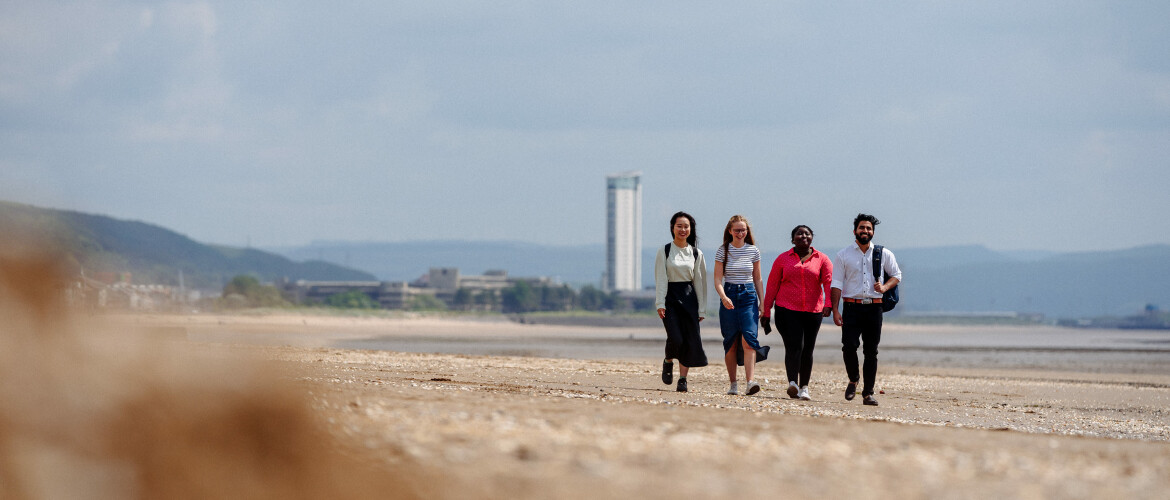 Students walking on a beach
