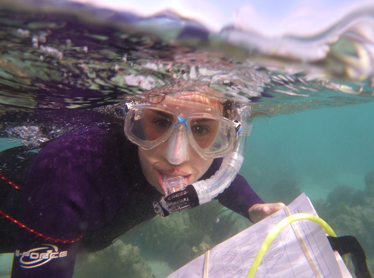 Student with snorkel in water
