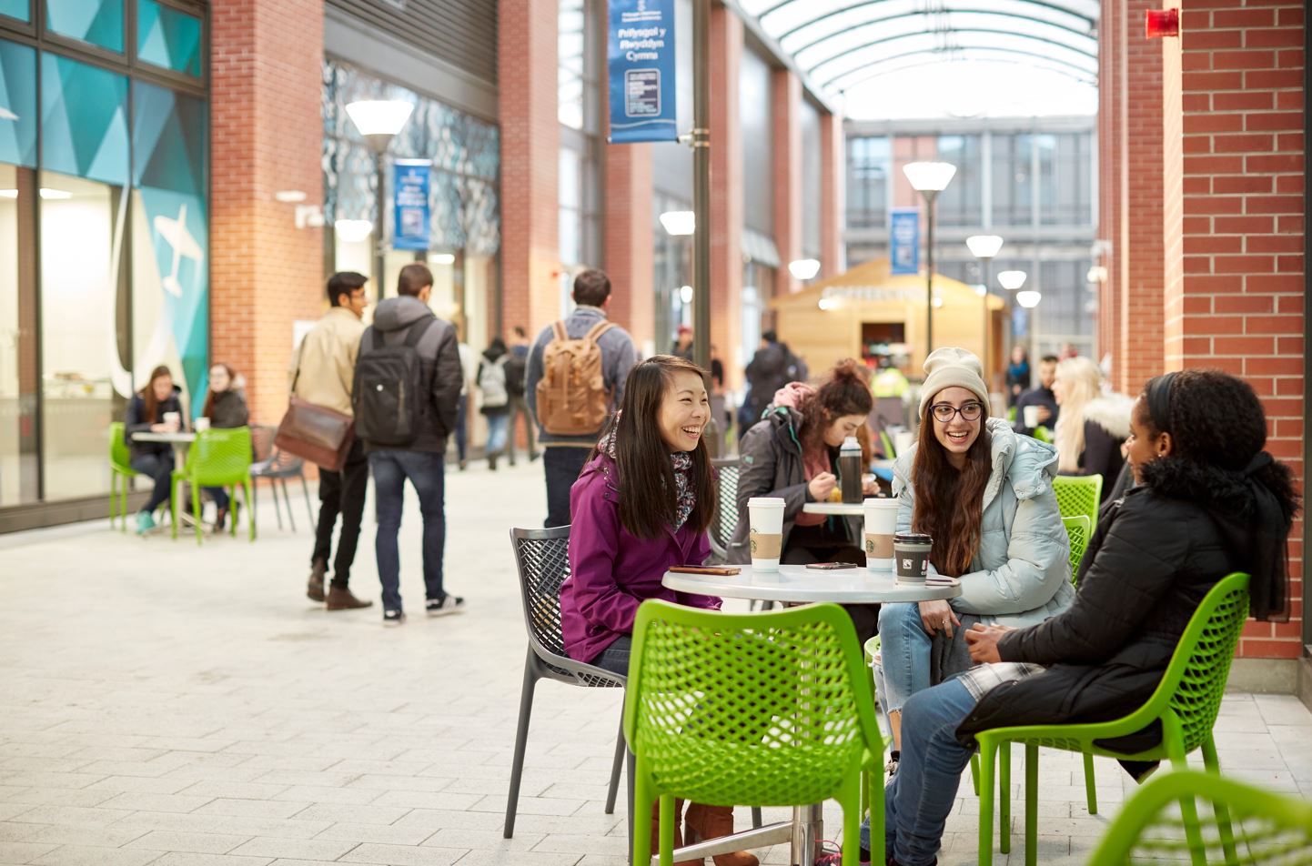 Students sitting at a table chatting in Engineering Central 