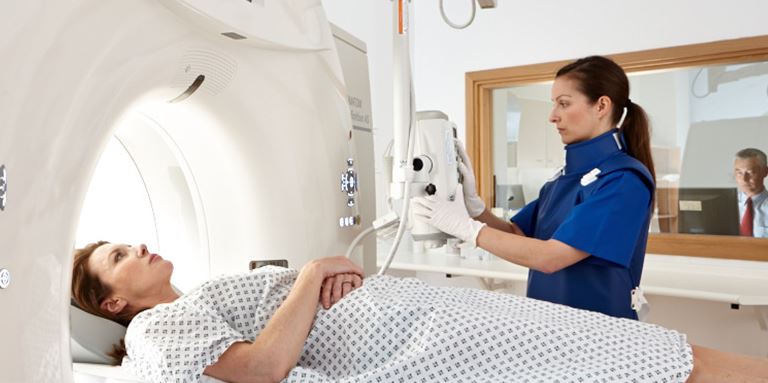 Patient and student with MRI machine