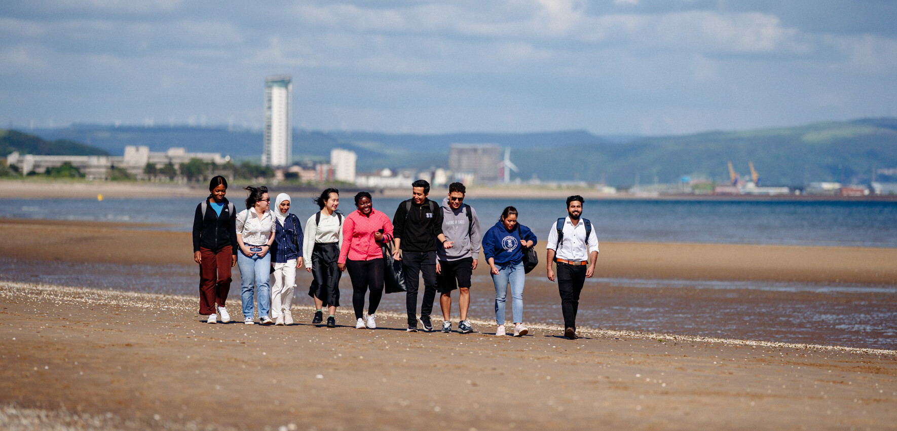 image of stduents walking on Swansea beach 