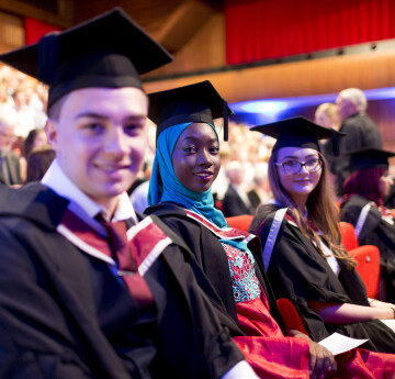 Three students at graduation 