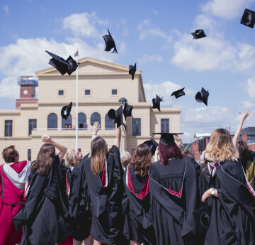 Graduates throwing their hats