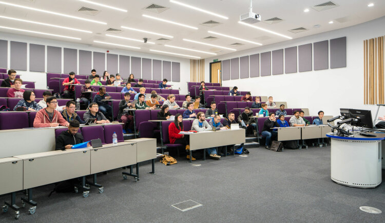 Many students sat in a lecture hall.