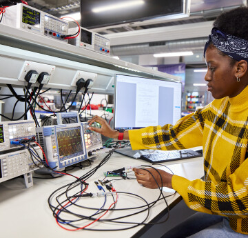 Electrical Engineering student testing electrical equipment at a desk
