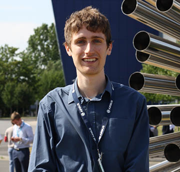 male student smiling outside Airbus