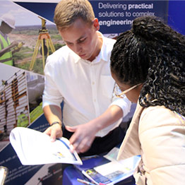 Picture of a student networking with an engineering industry representative. 