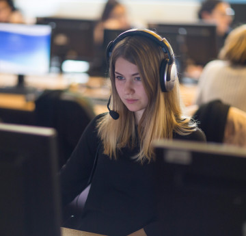girl with headset on computer