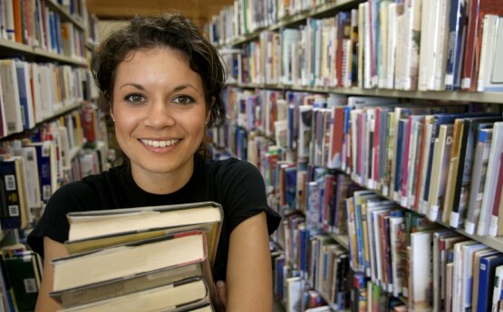 Smiling woman with books