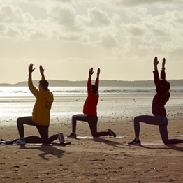 People doing yoga on Swansea beach
