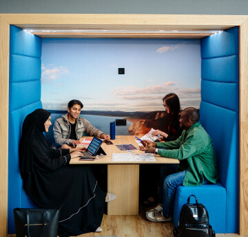 Students sitting together in a booth