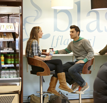 Who students talking at a table in Blas, an on-campus catering facility. 
