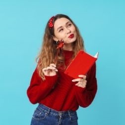 Girl holding a red book against a blue background